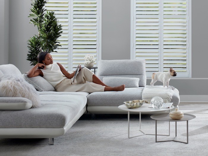 A living room with a set of two coffee tables and interesting objects.